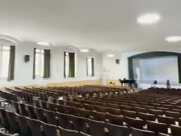 Auditorium seating and stage projection screen in one view.