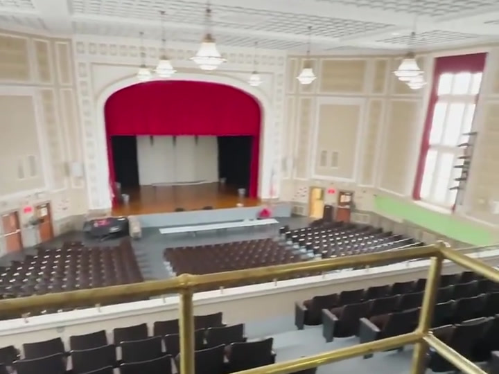 Wide auditorium view with the stage, balcony and seating.