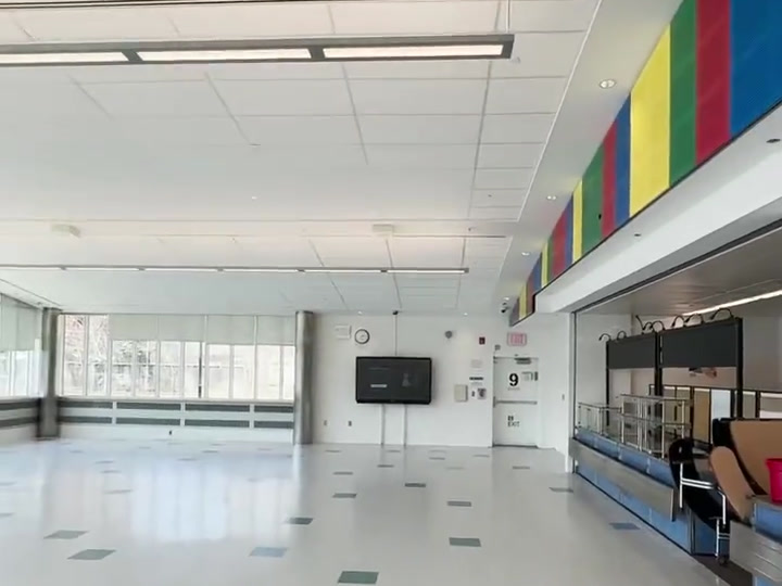 Wide cafeteria view showing the installed display and serving area.